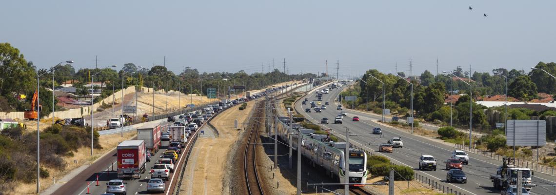 Major arterial road with railway line in between