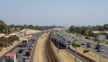 Major arterial road with railway line in between