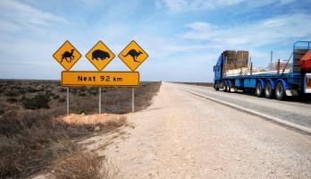 outback road with signage and heavy vehicle